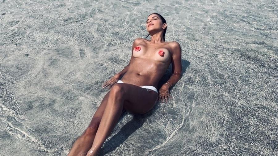 Atriz global posta foto só de calcinha fazendo topless na praia